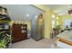 Yellow kitchen featuring stainless steel refrigerator, wooden cabinet, and multiple windows providing natural light at 6440 St Anthony Dr, Hollywood, SC 29449