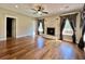 Bright living room featuring a fireplace, hardwood floors, and large windows at 6440 St Anthony Dr, Hollywood, SC 29449