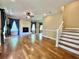Spacious living room with a fireplace, hardwood floors, and elegant blue curtains at 6440 St Anthony Dr, Hollywood, SC 29449