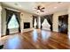 Spacious living room with a fireplace, hardwood floors, and elegant window curtains at 6440 St Anthony Dr, Hollywood, SC 29449