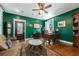 Stylish office with a wooden desk, hardwood floors, and unique green walls at 6440 St Anthony Dr, Hollywood, SC 29449