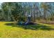 Outdoor playground with slide and swings in a wooded backyard at 6440 St Anthony Dr, Hollywood, SC 29449