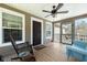 Relaxing screened-in porch with comfortable seating, a ceiling fan, and a wooden floor at 6440 St Anthony Dr, Hollywood, SC 29449