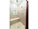 This is a close up of a shower with travertine tiles and a built-in seat at 6440 St Anthony Dr, Hollywood, SC 29449