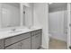 Bright bathroom with a double sink vanity, light gray cabinets and framed mirrors at 648 Chigwell Springs Ln, Summerville, SC 29486