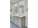 Bathroom featuring dual sinks, modern lighting, and grey cabinets with a beautiful blue rug at 648 Chigwell Springs Ln, Summerville, SC 29486