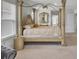 Bright bedroom featuring a regal four-poster bed and inviting seating area with large windows at 648 Chigwell Springs Ln, Summerville, SC 29486