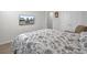 Comfortable bedroom boasts a floral comforter, wall-mounted TV, and a serene ambiance at 648 Chigwell Springs Ln, Summerville, SC 29486