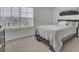 Bedroom with a large window, gray walls and a queen sized bed with white bedding at 648 Chigwell Springs Ln, Summerville, SC 29486