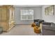 Bedroom offers a cozy seating area, wooden armoire and a bright window at 648 Chigwell Springs Ln, Summerville, SC 29486