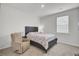 Bright bedroom featuring a plush recliner and a comfortable bed with a stylish headboard at 648 Chigwell Springs Ln, Summerville, SC 29486