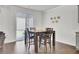 Well-lit dining area with wooden table, chairs, and sliding glass door leading to outdoor patio at 648 Chigwell Springs Ln, Summerville, SC 29486