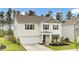 Charming two-story home with landscaped yard, attached garage, and traditional architectural details at 648 Chigwell Springs Ln, Summerville, SC 29486
