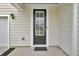 Close-up of a stylish front door with a window, providing a welcoming entrance to the home at 648 Chigwell Springs Ln, Summerville, SC 29486