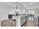 Kitchen open concept with stainless steel appliances, island, living and dining rooms at 648 Chigwell Springs Ln, Summerville, SC 29486