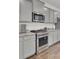 Updated kitchen with gray cabinets, stainless appliances, and granite countertops at 648 Chigwell Springs Ln, Summerville, SC 29486