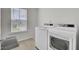 Clean laundry room with modern washer and dryer and a window providing natural light at 648 Chigwell Springs Ln, Summerville, SC 29486