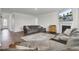 Bright living room featuring hardwood floors, fireplace, television, and comfortable sectional sofa at 648 Chigwell Springs Ln, Summerville, SC 29486