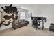 Cozy living room with a gray sofa, black and white cow hide and a computer gaming setup at 648 Chigwell Springs Ln, Summerville, SC 29486