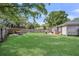 Large backyard with a rock fire pit, covered hammock, backyard deck, grill, and grass lawn at 733 Longfellow Rd, Charleston, SC 29407