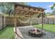 Backyard with a rock fire pit, covered hammock, and a grass lawn at 733 Longfellow Rd, Charleston, SC 29407