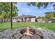 Backyard with a rock fire pit, backyard deck, grill, and grass lawn at 733 Longfellow Rd, Charleston, SC 29407