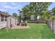 Fenced backyard featuring a spacious lawn, deck with seating, and a charming pergola at 733 Longfellow Rd, Charleston, SC 29407