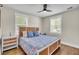 Bright bedroom with hardwood floors, patterned bedding, and natural light at 733 Longfellow Rd, Charleston, SC 29407