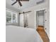 Bright bedroom with a sliding barn door to the bathroom and natural light from the window at 733 Longfellow Rd, Charleston, SC 29407