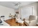 Bright bedroom featuring hardwood floors, a ceiling fan, an area for chairs, and an area with a desk at 733 Longfellow Rd, Charleston, SC 29407