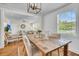 Light-filled dining room featuring a rustic wood table, shiplap wall, and views of the living area at 733 Longfellow Rd, Charleston, SC 29407