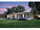 Charming home featuring a well-maintained lawn and inviting curb appeal at twilight at 733 Longfellow Rd, Charleston, SC 29407