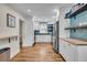 Bright kitchen with white cabinets, modern stainless appliances, blue backsplash, and hardwood floors at 733 Longfellow Rd, Charleston, SC 29407