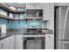 View of the oven range and countertops of this nicely updated kitchen, and a stainless refrigerator at 733 Longfellow Rd, Charleston, SC 29407