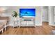 Bright living room featuring hardwood floors, comfortable seating, and a large television for entertainment at 733 Longfellow Rd, Charleston, SC 29407