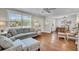 Comfortable living room featuring hardwood floors, stylish seating, and a seamless flow to the dining area at 733 Longfellow Rd, Charleston, SC 29407