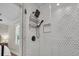Modern walk-in shower featuring hexagon tiles, matte black fixtures, and recessed storage at 733 Longfellow Rd, Charleston, SC 29407