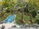 Aerial view of a backyard with a swimming pool, patio, and mature trees, offering privacy at 739 Wildwood Rd, Charleston, SC 29412