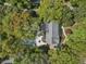 An aerial view of the home with a pool, patio area, long driveway, and surrounded by mature trees at 739 Wildwood Rd, Charleston, SC 29412