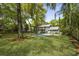 A large backyard featuring a pool, patio area, and mature trees creating a beautiful outdoor space at 739 Wildwood Rd, Charleston, SC 29412