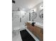 Bathroom showcasing a double sink vanity, white hexagon tile and seamless glass shower at 739 Wildwood Rd, Charleston, SC 29412