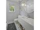 Beautiful bathroom with stylish fixtures, patterned wallpaper, and a round mirror at 739 Wildwood Rd, Charleston, SC 29412