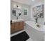 Bright bathroom featuring a freestanding tub, black accents and hexagon backsplash at 739 Wildwood Rd, Charleston, SC 29412