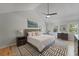 Bright bedroom featuring a vaulted ceiling, ceiling fan, and an accent wall art piece at 739 Wildwood Rd, Charleston, SC 29412