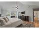 Spacious bedroom with a ceiling fan, walk-in closet and light gray walls and striped rug at 739 Wildwood Rd, Charleston, SC 29412