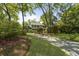 A charming two-story home with a long driveway, surrounded by mature trees and lush landscaping at 739 Wildwood Rd, Charleston, SC 29412