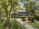 Stately two-story home with a welcoming front porch and driveway lined with mature trees at 739 Wildwood Rd, Charleston, SC 29412