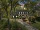 Charming home at dusk with a covered porch, mature landscaping, and a welcoming, lit exterior at 739 Wildwood Rd, Charleston, SC 29412