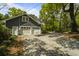 Spacious three-car garage with ample parking space and mature trees providing shade on the long driveway at 739 Wildwood Rd, Charleston, SC 29412