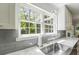 A stylish kitchen sink next to double windows provides natural light and a picturesque view at 739 Wildwood Rd, Charleston, SC 29412